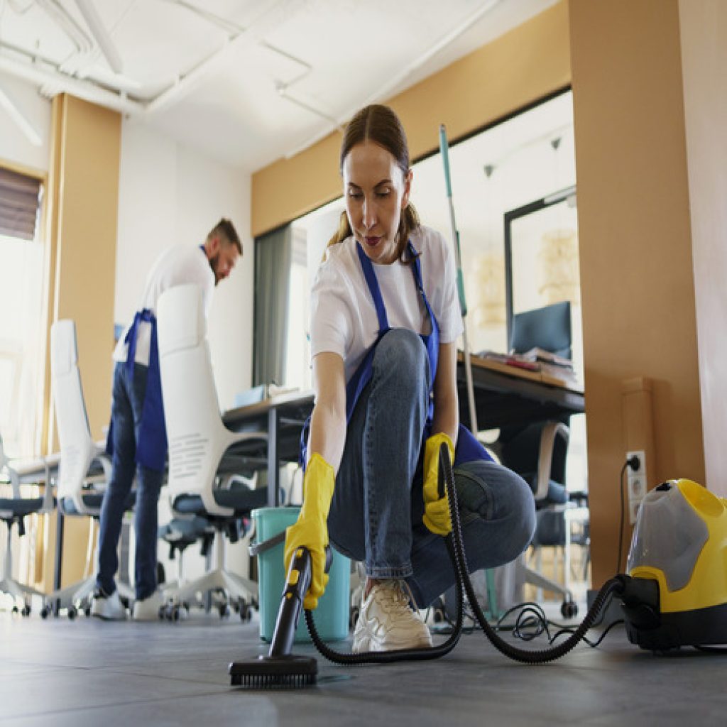 professional-cleaning-service-person-using-vacuum-cleaner-office